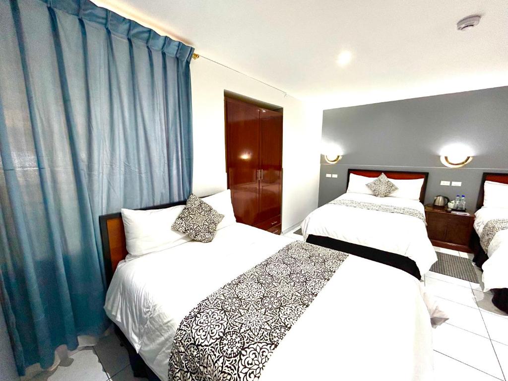 Postel nebo postele na pokoji v ubytování ACCEL Hotel La Quinta