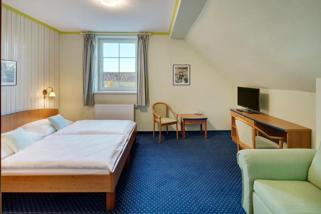Postel nebo postele na pokoji v ubytování Hotel Kolonie