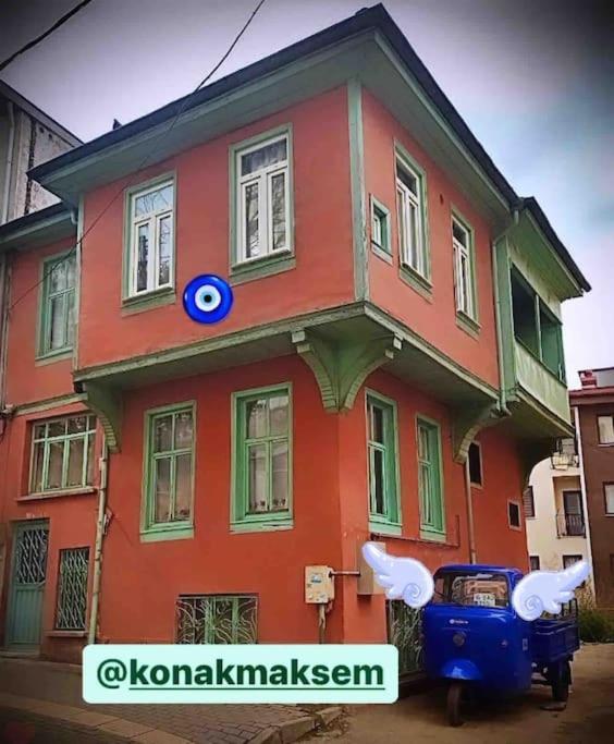 a red house with a blue sign in front of it at Konak Maksem in Bursa