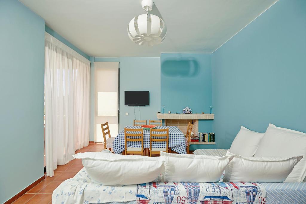 a living room with a couch and a table at soft blue apartment near seaside in Porto Rafti