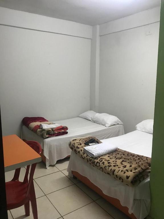 Postel nebo postele na pokoji v ubytování Don Carmelo Hotel