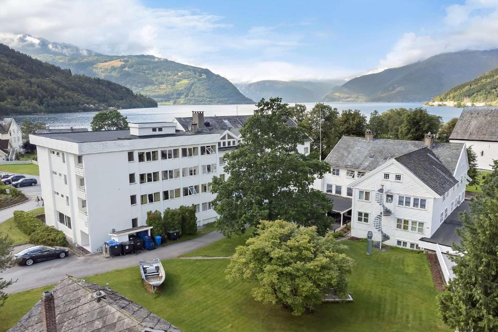 an aerial view of a large white building with a lake at Kinsarvik Fjordhotel, BW Signature Collection in Kinsarvik