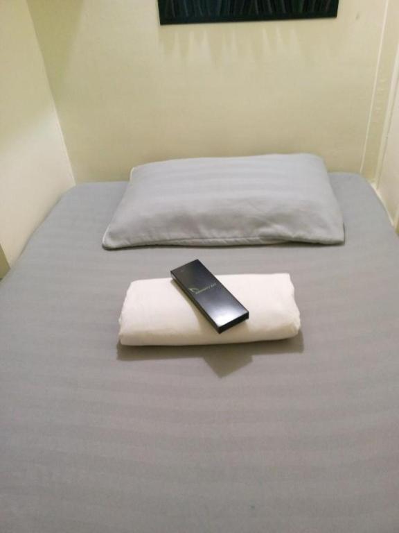 Postel nebo postele na pokoji v ubytování RDC- Baclaran Transient Capsule