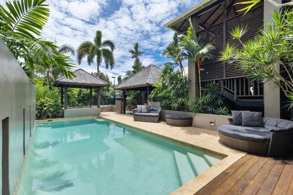 a swimming pool in the backyard of a house at 35 Beachfront Mirage Port Douglas in Port Douglas