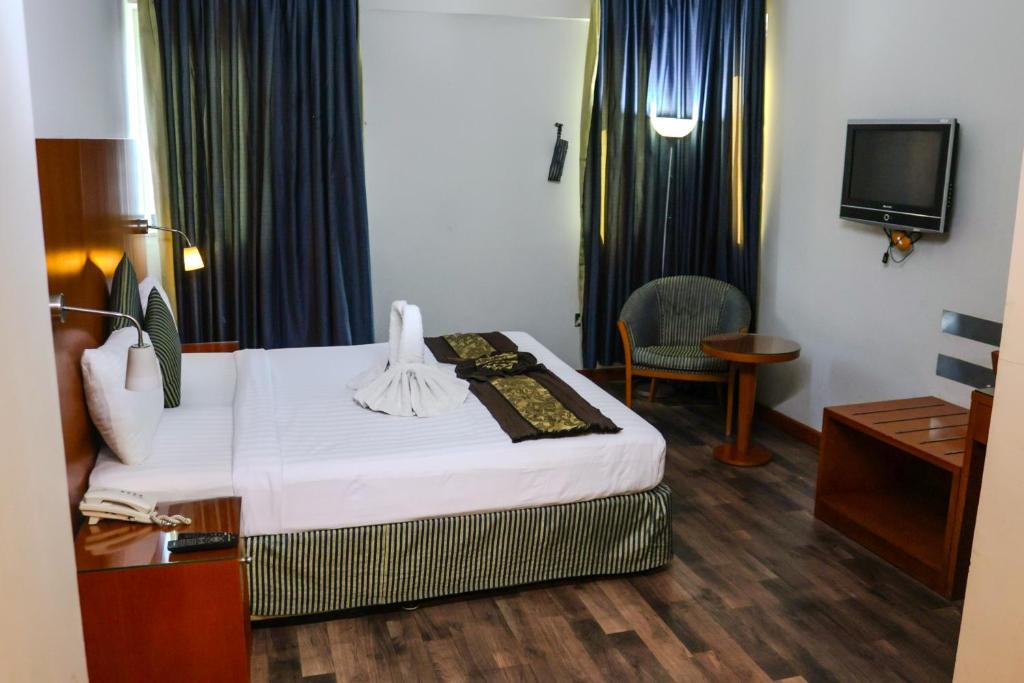Postel nebo postele na pokoji v ubytování BOONMAX Hotel