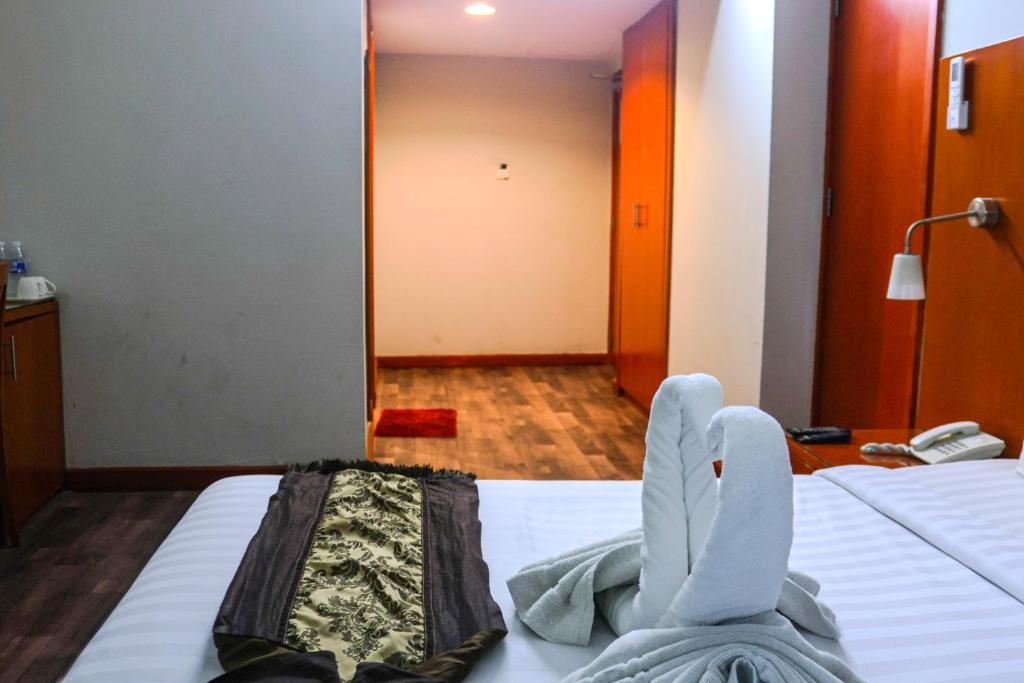 Postel nebo postele na pokoji v ubytování BOONMAX Hotel