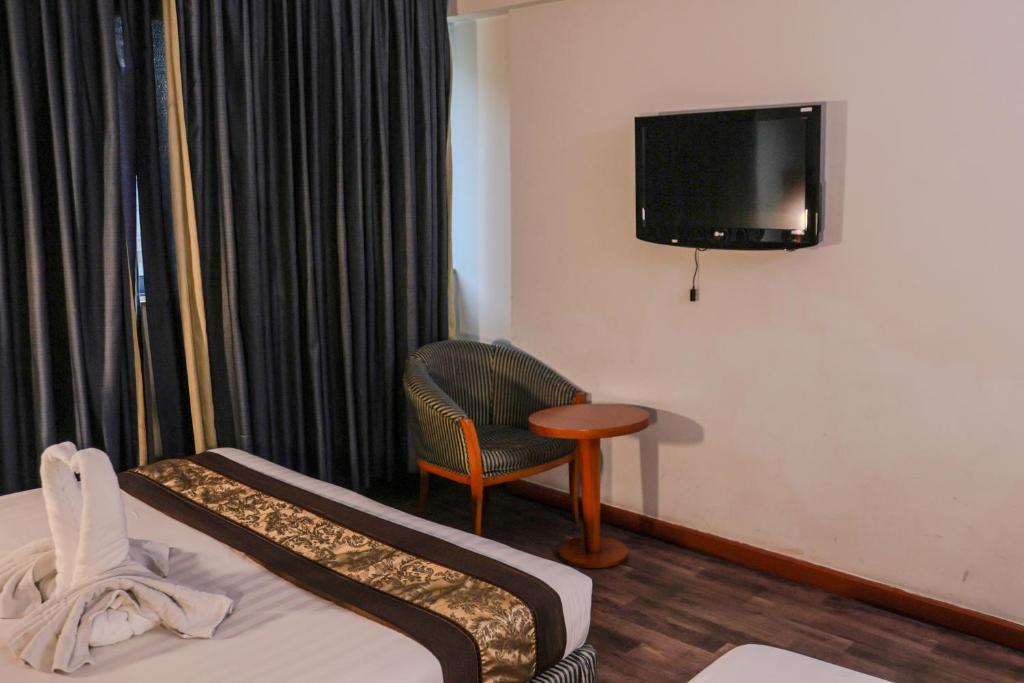 TV a/nebo společenská místnost v ubytování BOONMAX Hotel