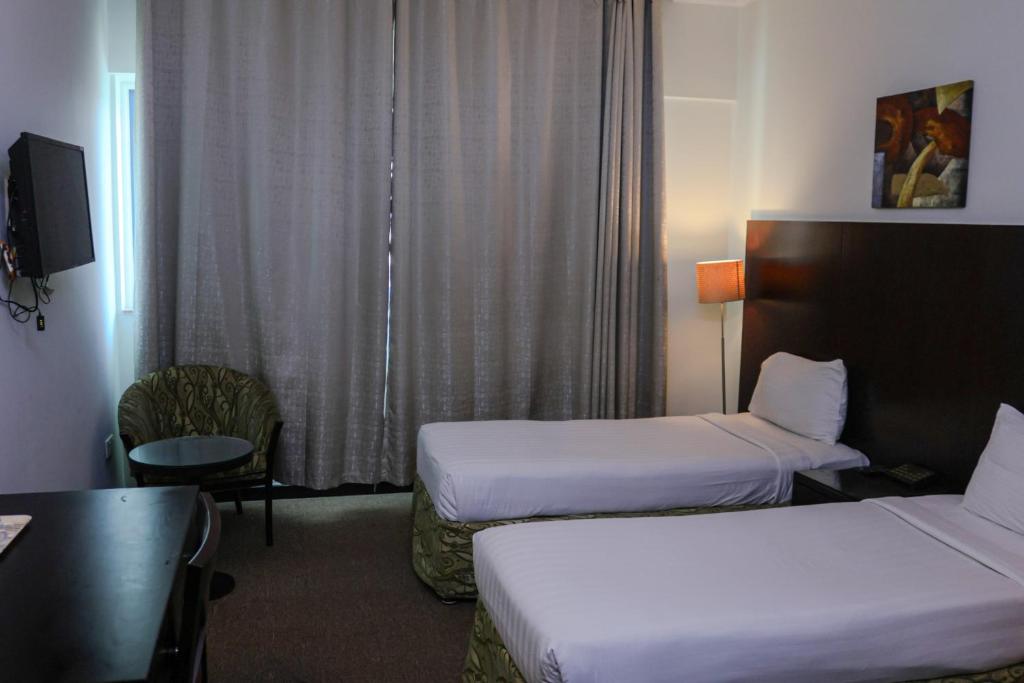 Postel nebo postele na pokoji v ubytování BOONMAX Hotel