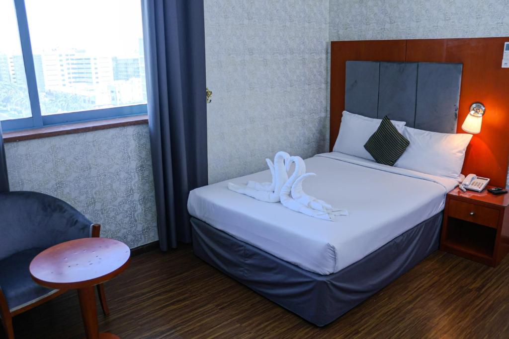 Postel nebo postele na pokoji v ubytování BOONMAX Hotel