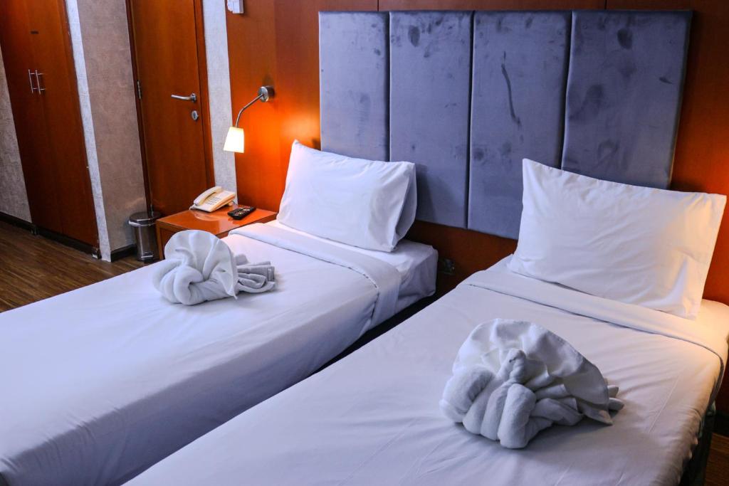 Postel nebo postele na pokoji v ubytování BOONMAX Hotel