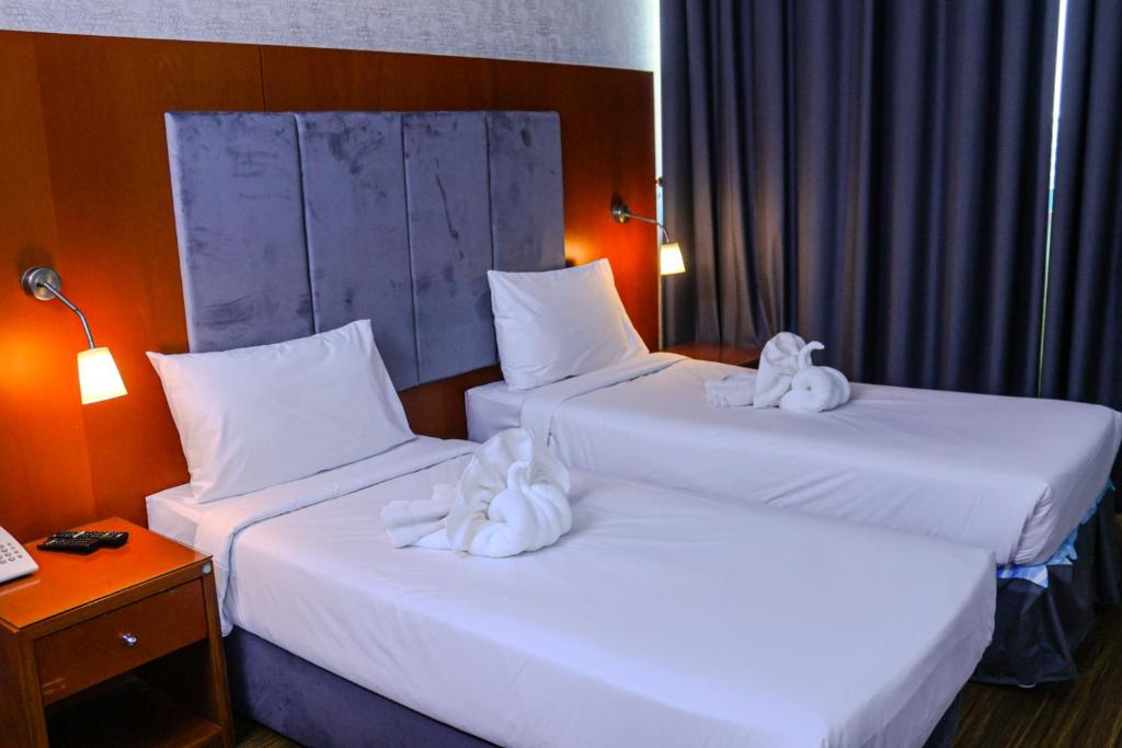 Postel nebo postele na pokoji v ubytování BOONMAX Hotel