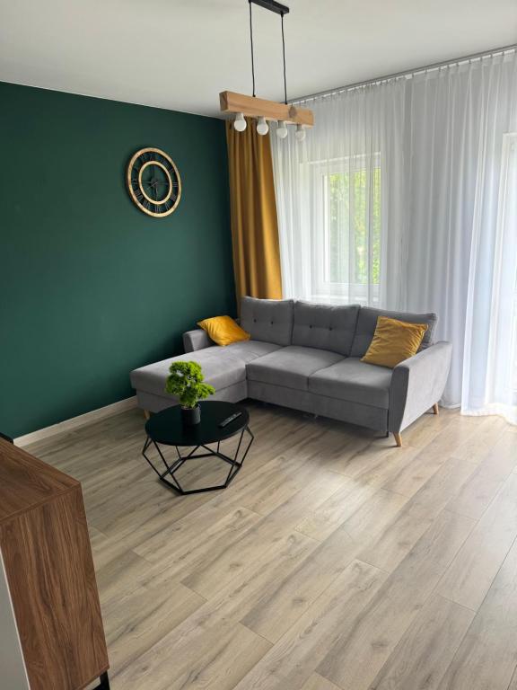 a living room with a couch and a table at # Marysieńka in Busko-Zdrój