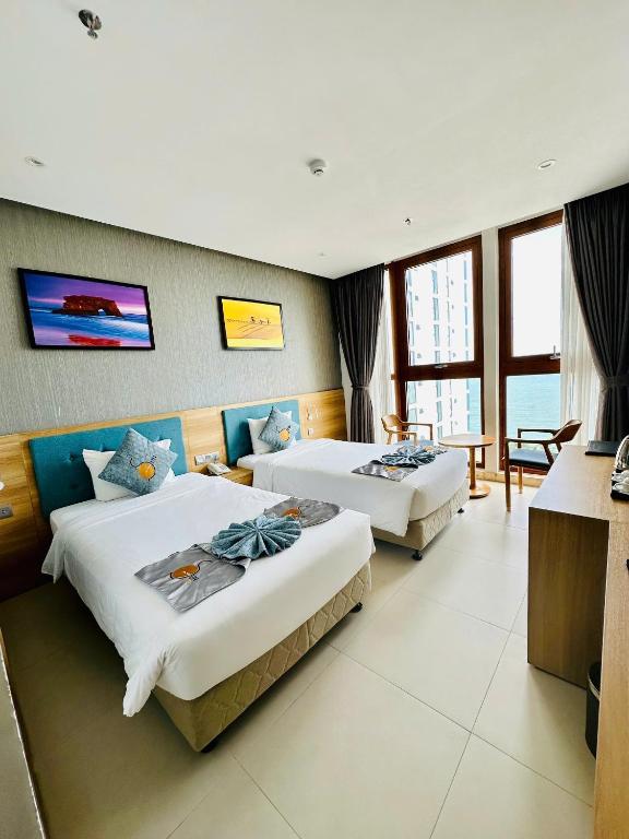 Postel nebo postele na pokoji v ubytování Sun Kiss Hotel
