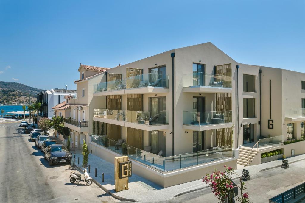a large white building with cars parked on the street at G Boutique Hotel Kefalonia in Argostoli