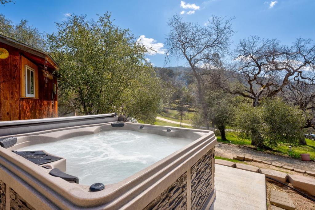 a hot tub sitting on top of a house at Selah Cabin- Dog Friendly/BBQ/Level 2 EV Charger in Yosemite Forks