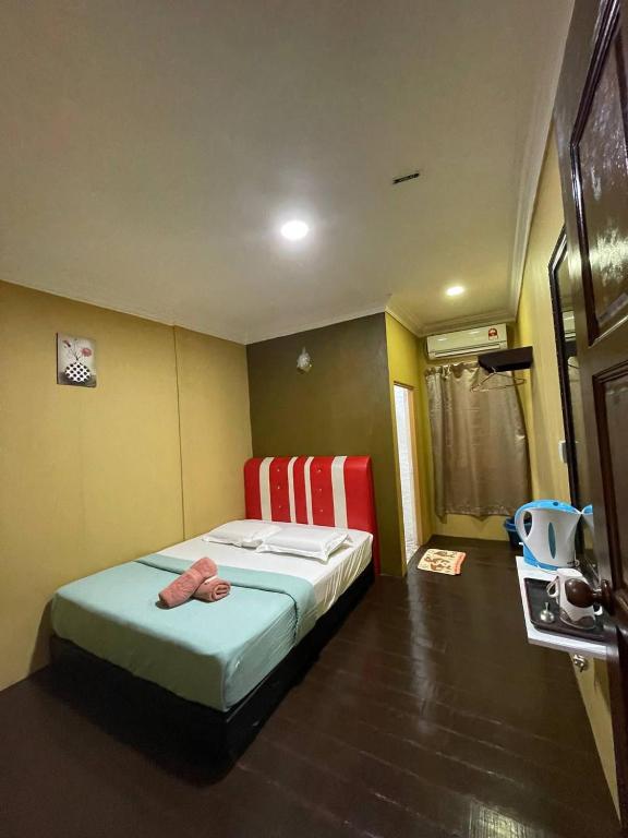 Postel nebo postele na pokoji v ubytování Perhentian Village Inn