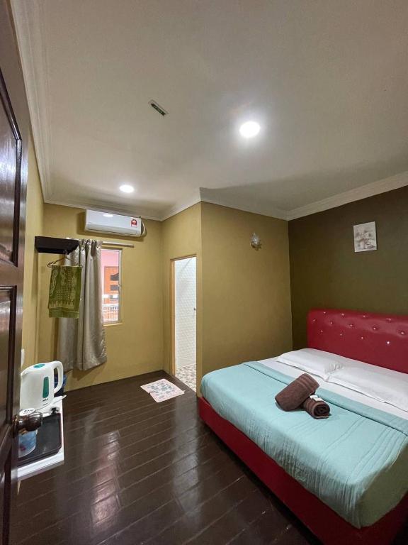 Postel nebo postele na pokoji v ubytování Perhentian Village Inn