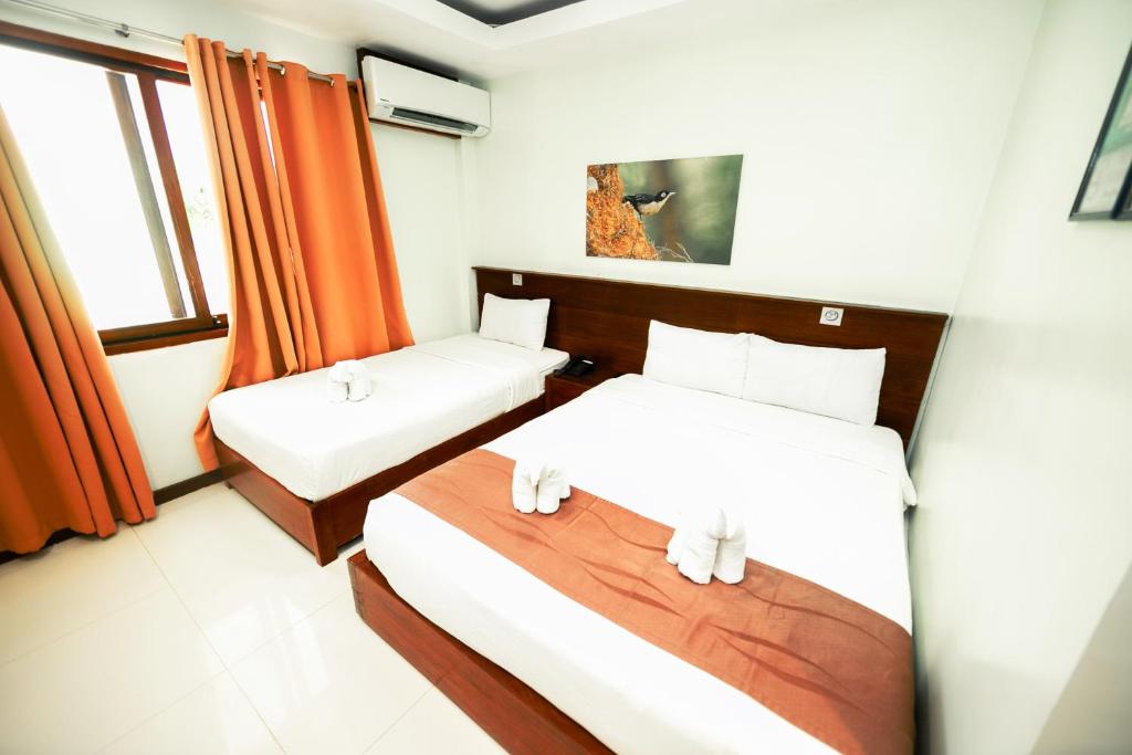 Postel nebo postele na pokoji v ubytování Marianne Hotel