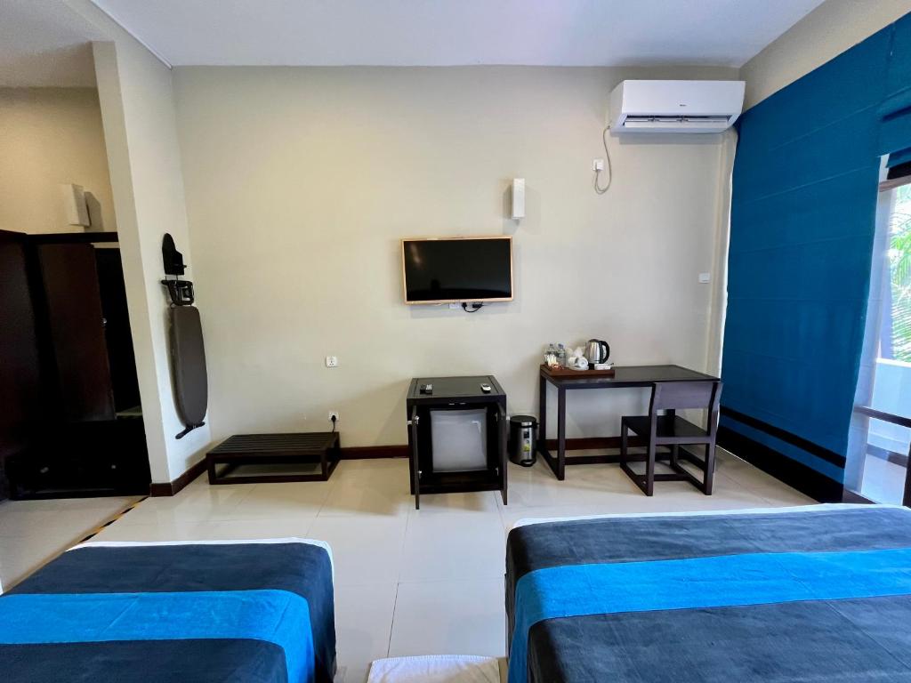 Postel nebo postele na pokoji v ubytování Hotel Randiya Anuradhapura