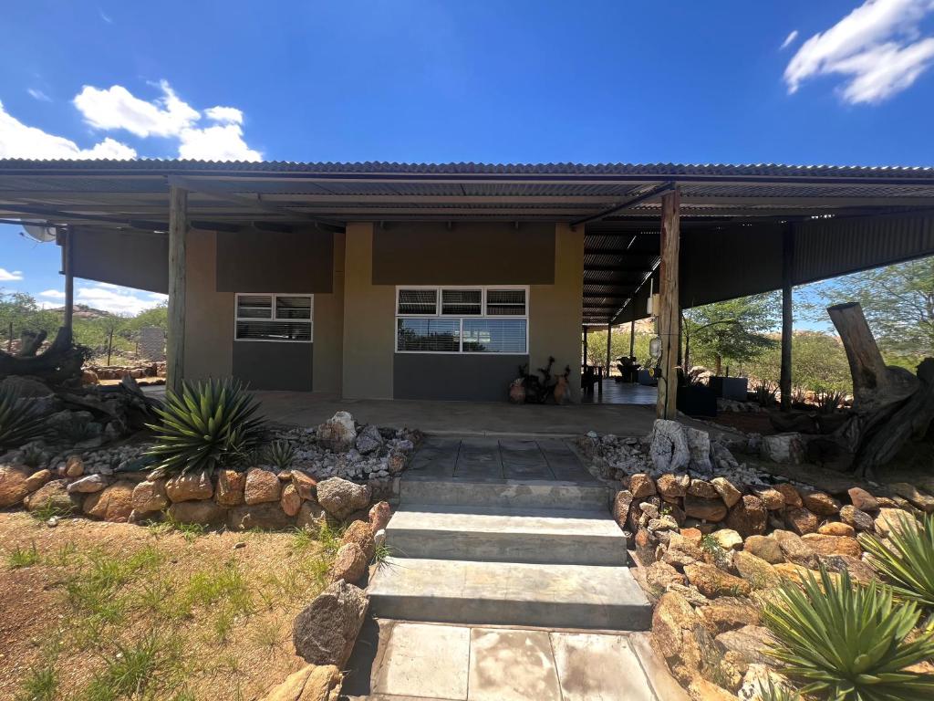a house with a stone walkway in front of it at Karibu Self-Catering Unit 1 in Omaruru