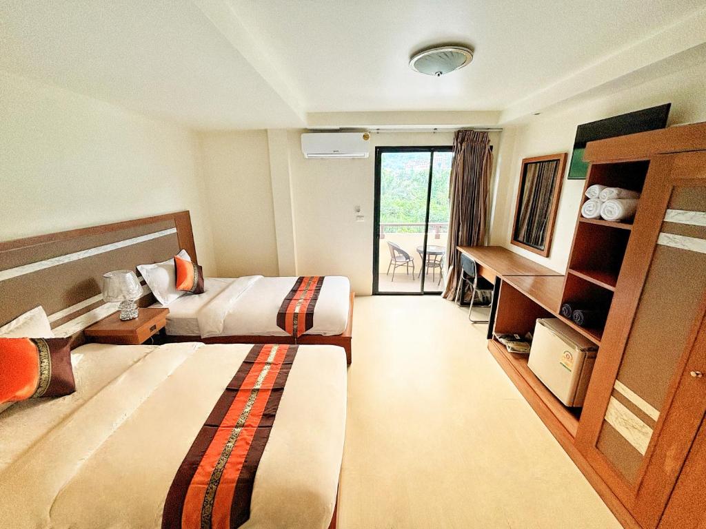 Postel nebo postele na pokoji v ubytování patong v hotel