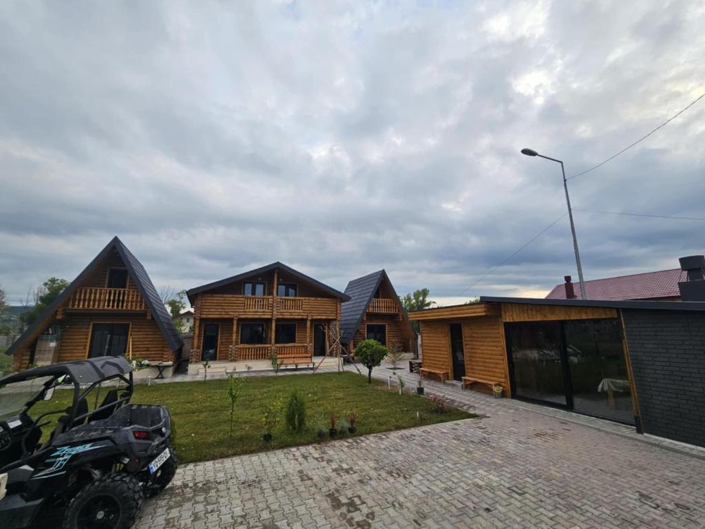 a house with a car parked in front of it at Eco House Bazaleti Lake in Dushetʼi