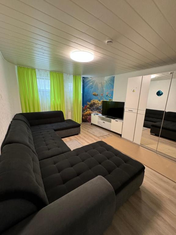 a bedroom with a large black bed and a fish tank at Täles Monteur Quartier in Deggingen