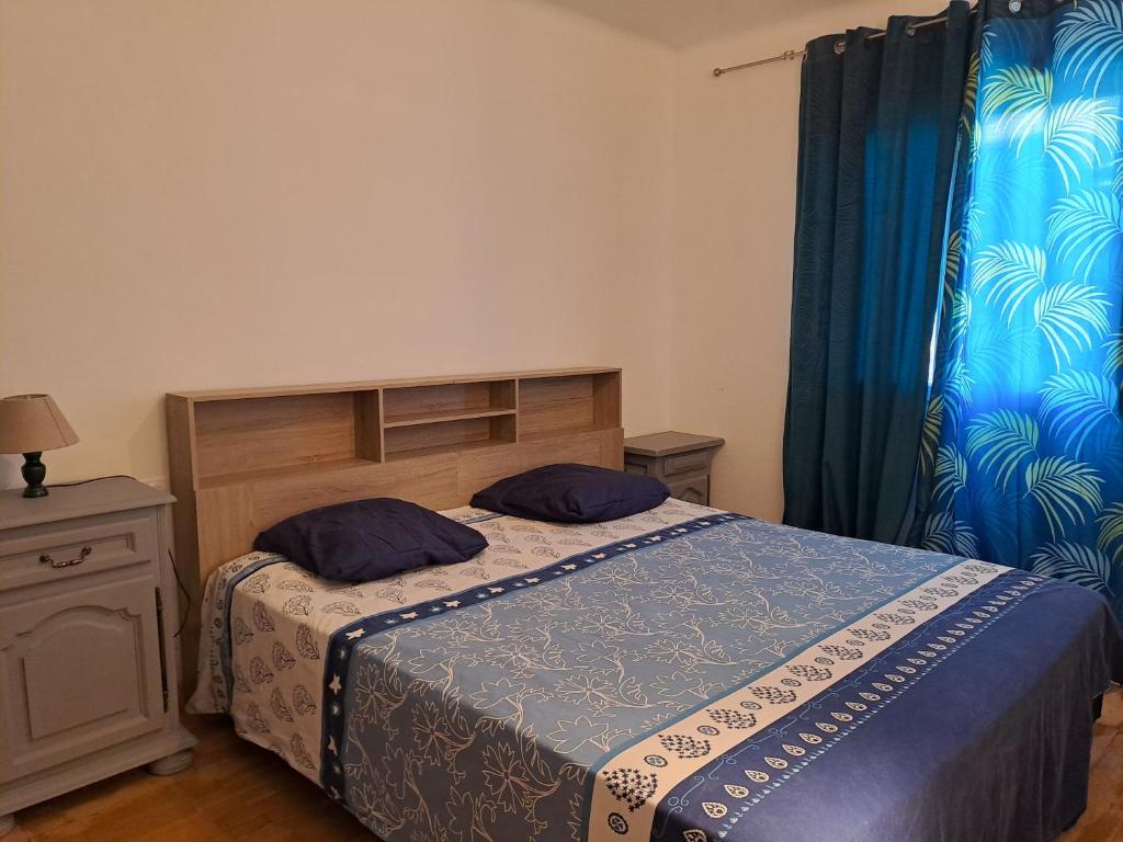 une chambre avec un lit avec deux oreillers dessus dans l'établissement Appart à 15 minutes de la plage, à Perpignan