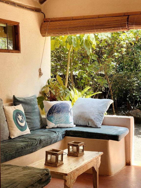 a living room with a couch and a coffee table at Ol Losowan House and Cottages in Nairobi