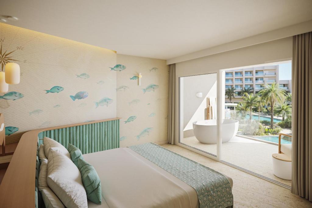 Postel nebo postele na pokoji v ubytování JOIA Aruba by Iberostar