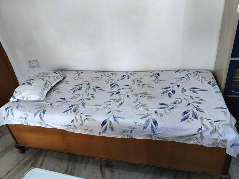 a bed with a white comforter on it in a bedroom at Perfect Stay for Working People in Patna