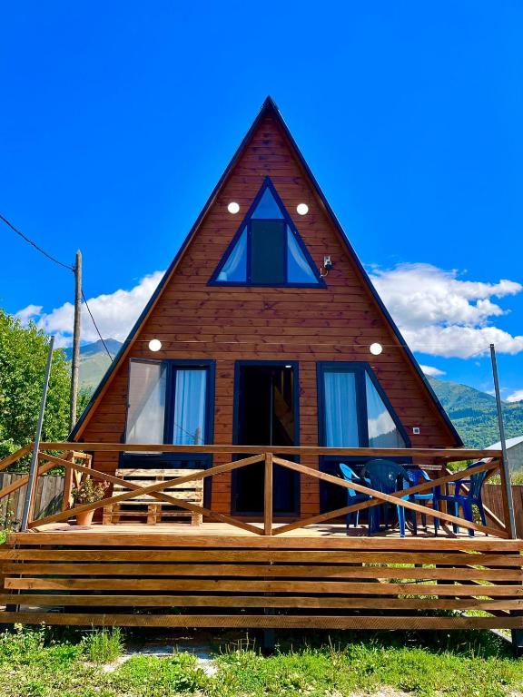 a log cabin with a thatched roof at Lela's Cottage in Mestia