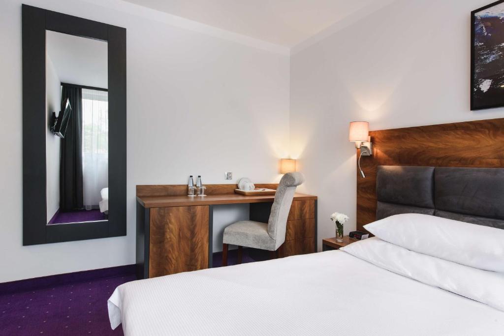 Ein Bett oder Betten in einem Zimmer der Unterkunft Best Western Plus Hotel Olsztyn Old Town