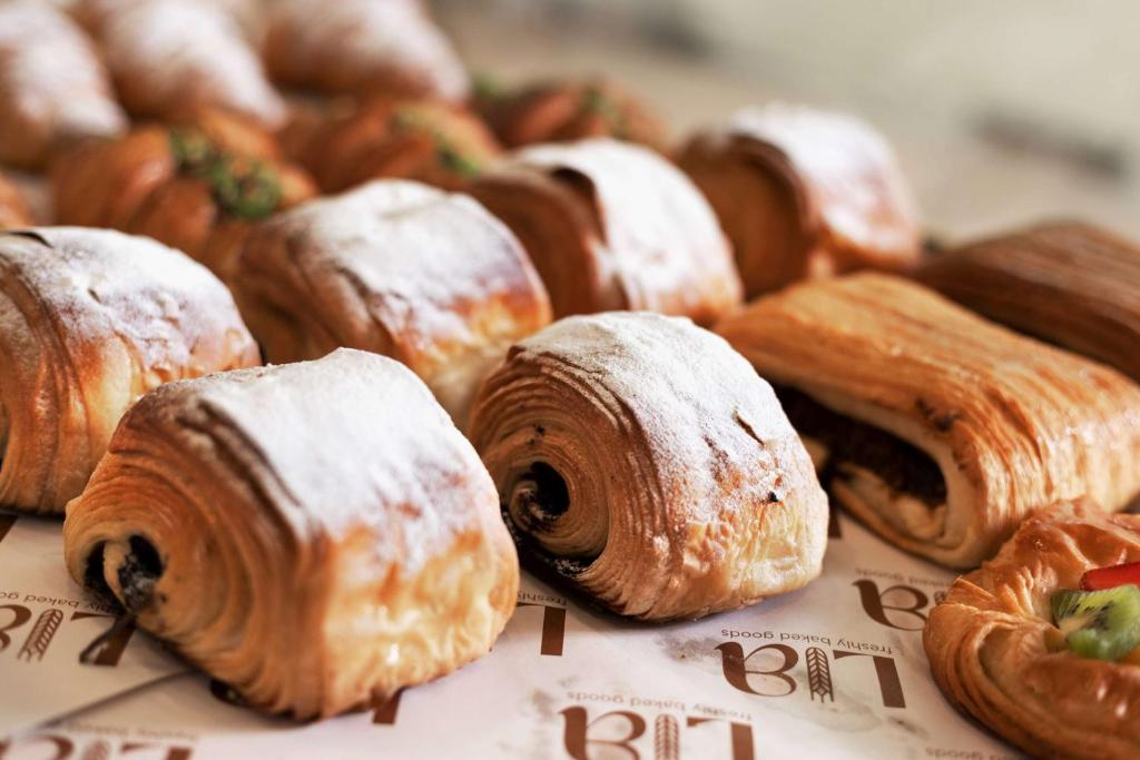 a bunch of pastries sitting on top of a table at Wyndham Panbil Batam in Batam Center