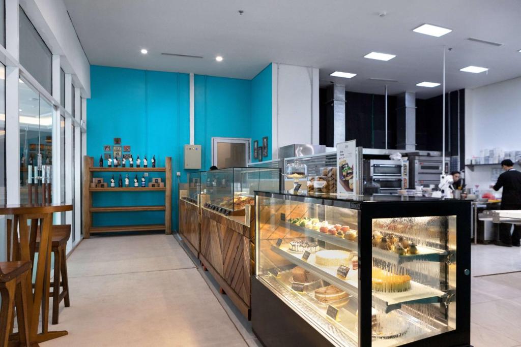 a bakery with a display case filled with pastries at Wyndham Panbil Batam in Batam Center
