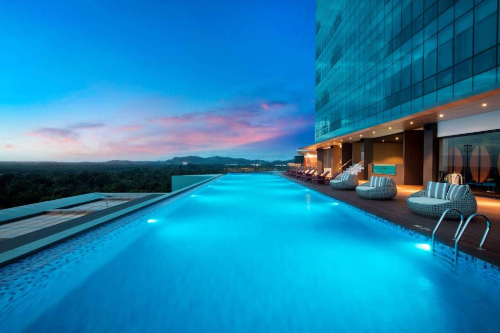 a swimming pool in the middle of a building at Wyndham Panbil Batam in Batam Center