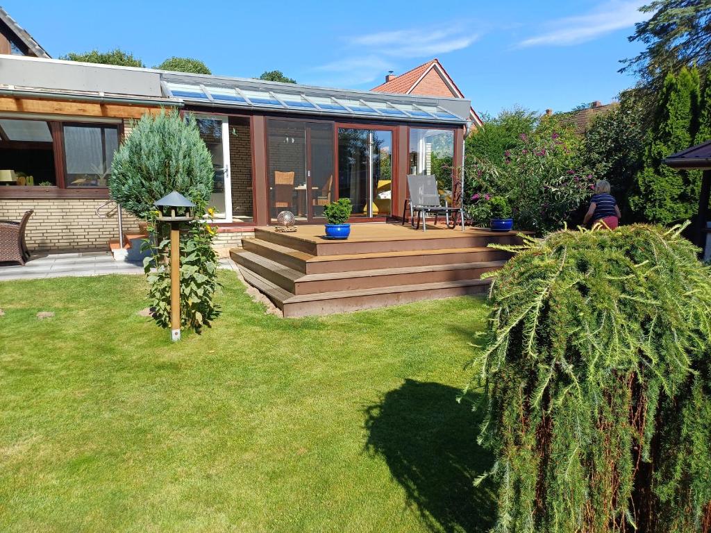 a home with a deck and a house at Ferienhaus Timm in Meldorf