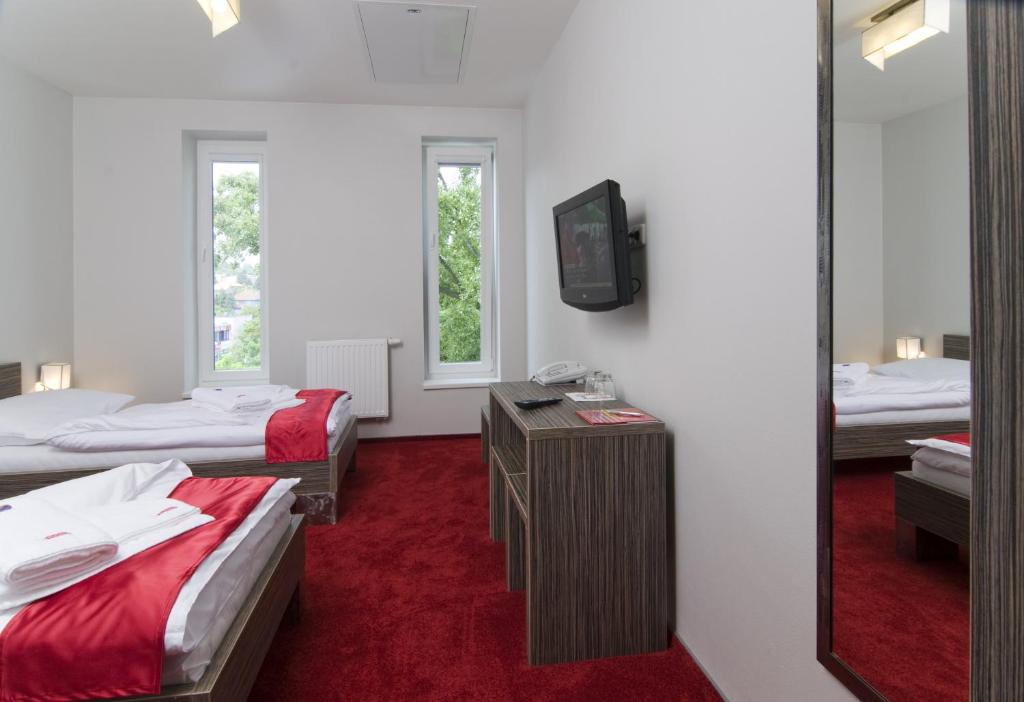 Postel nebo postele na pokoji v ubytování Hotel Olympia