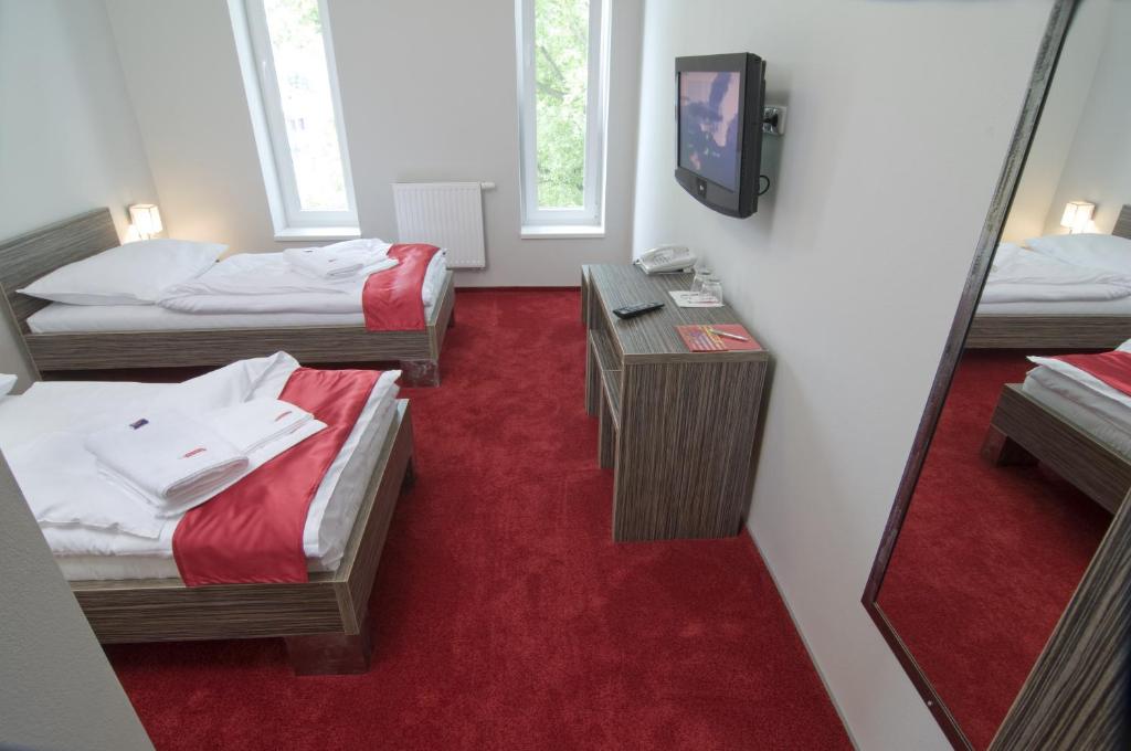 Postel nebo postele na pokoji v ubytování Hotel Olympia