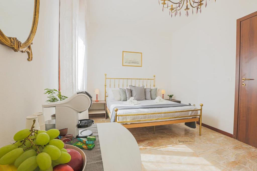 a bedroom with a bed and a table with fruit at SUITE Le Barche in Mestre