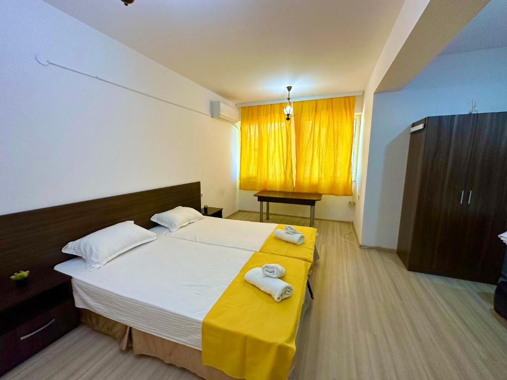 a bedroom with a bed with two towels on it at Guest Rooms Lina in Kirkovo