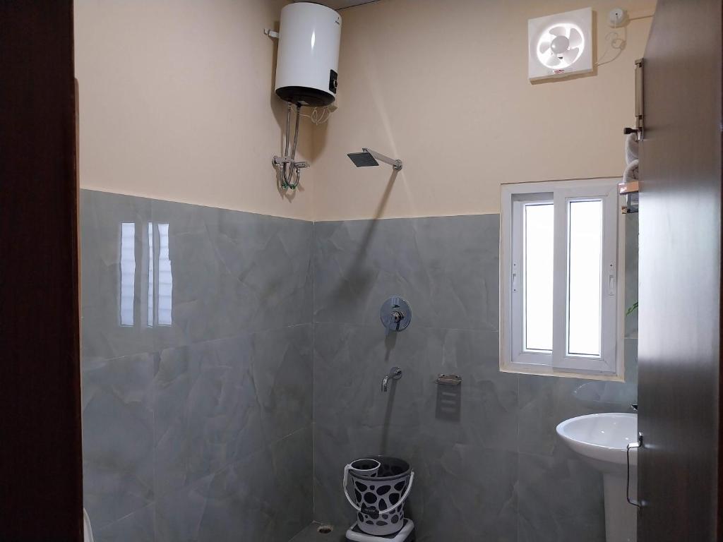 a bathroom with a shower and a sink at Bononi in Jorhāt