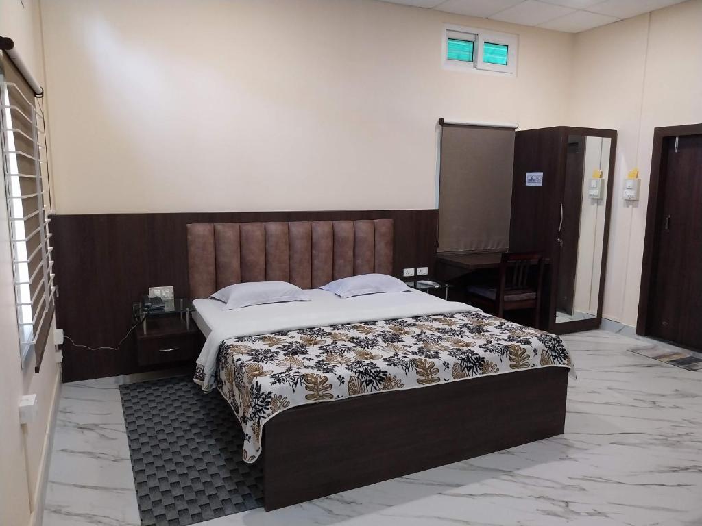 a bedroom with a large bed in a room at Bononi in Jorhāt