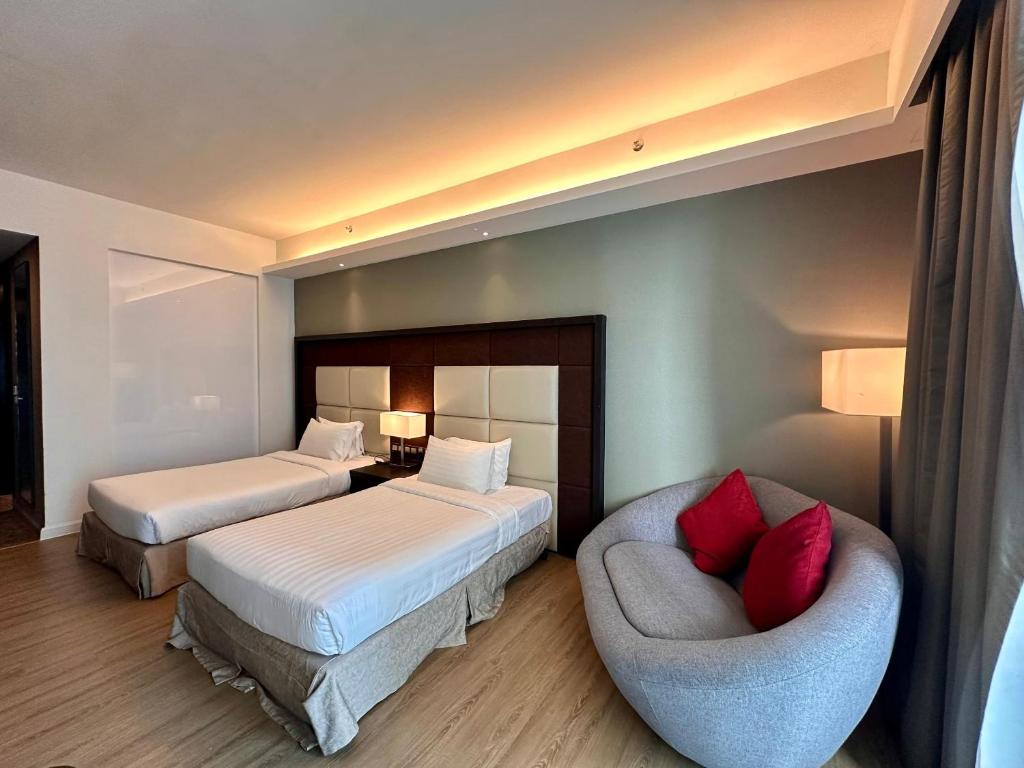 Postel nebo postele na pokoji v ubytování Swiss-Garden Hotel Melaka