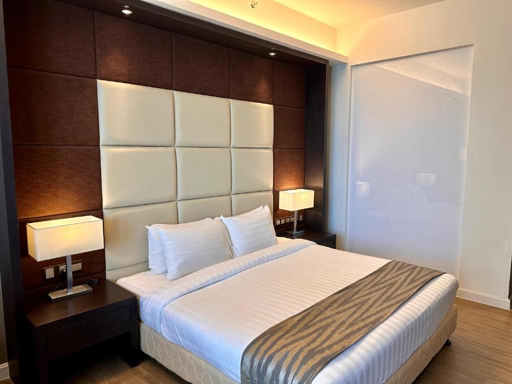 Postel nebo postele na pokoji v ubytování Swiss-Garden Hotel Melaka