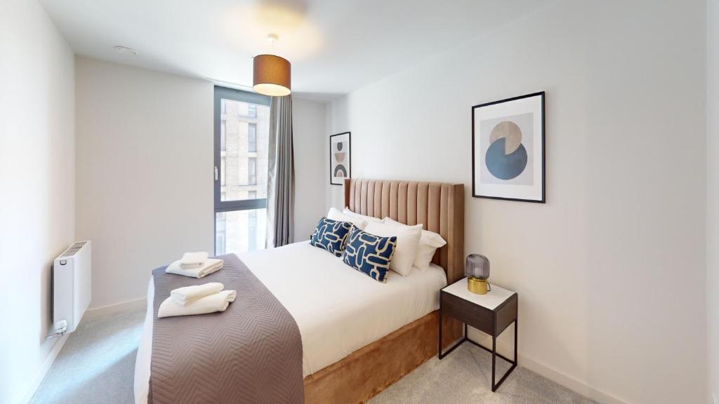 a white bedroom with a bed and a window at Charles Hope Brighton & Hove in Brighton & Hove