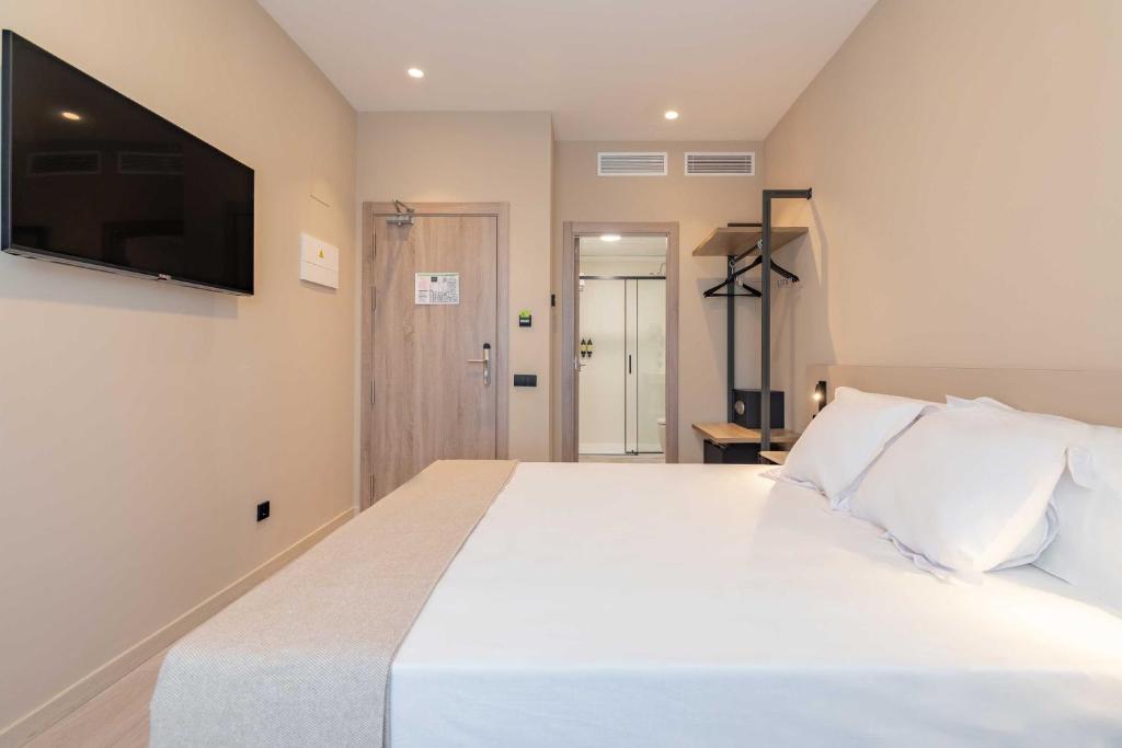 Postel nebo postele na pokoji v ubytování HQ Arena Hotel