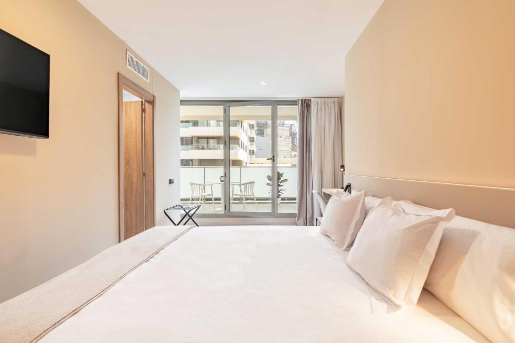 Postel nebo postele na pokoji v ubytování HQ Arena Hotel