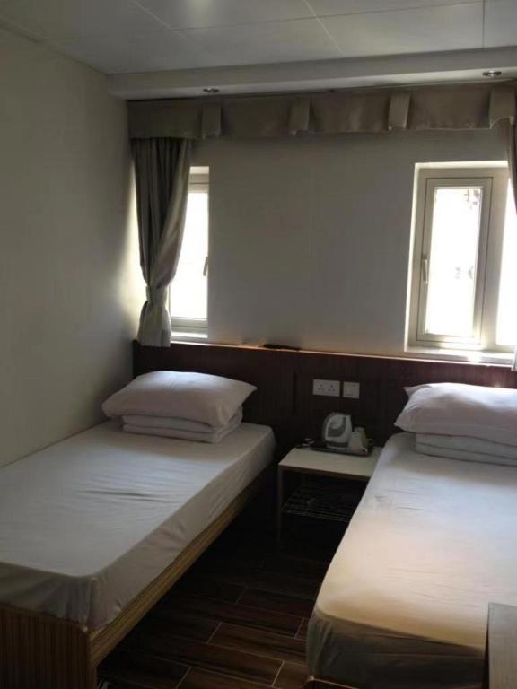 Voodi või voodid majutusasutuse 香港金門賓館 KamMun Guest House toas