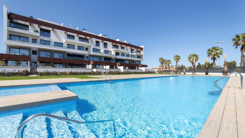 a large swimming pool in front of a building at Oceans Oliva in Oliva